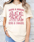 Model wearing natural color shirt with 'Save A Horse Ride A Cowgirl' graphic design
